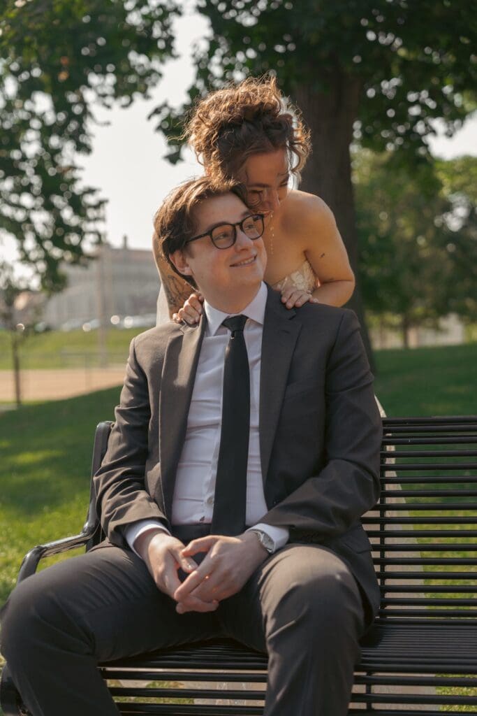 Candid photo of a bride hugging her groom from behind surprising him with a first look