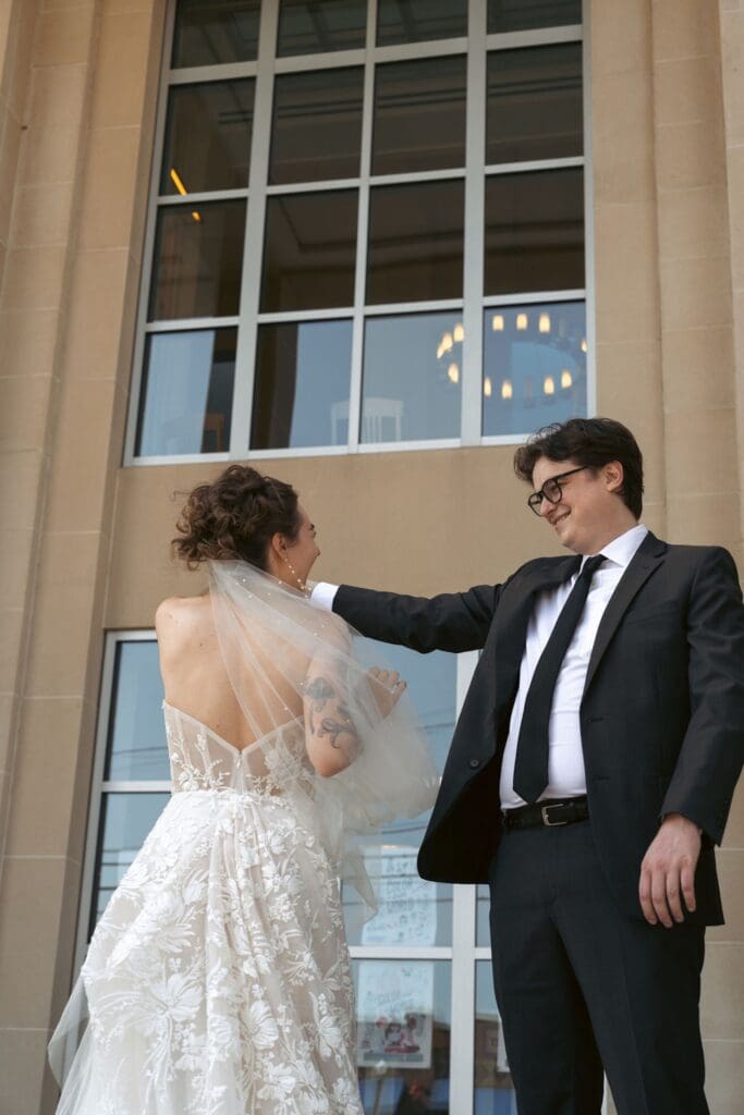 Bride and groom dancing outside a Library
