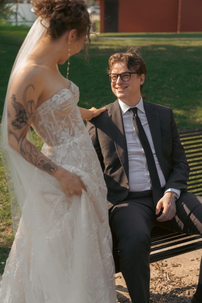 A candid photo of the groom seeing his bride for the very first time