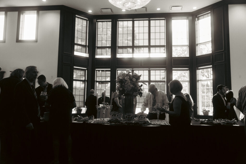Guests in a big room having cocktail hour before reception starts