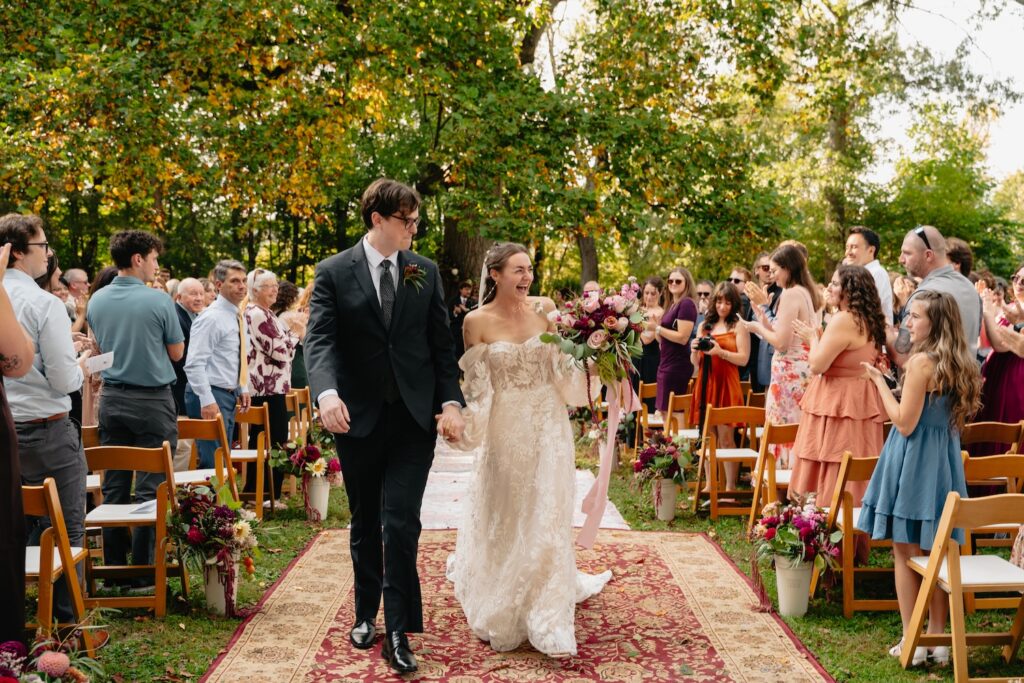 Bride and groom walking down the aisle after they got married at their ceremony