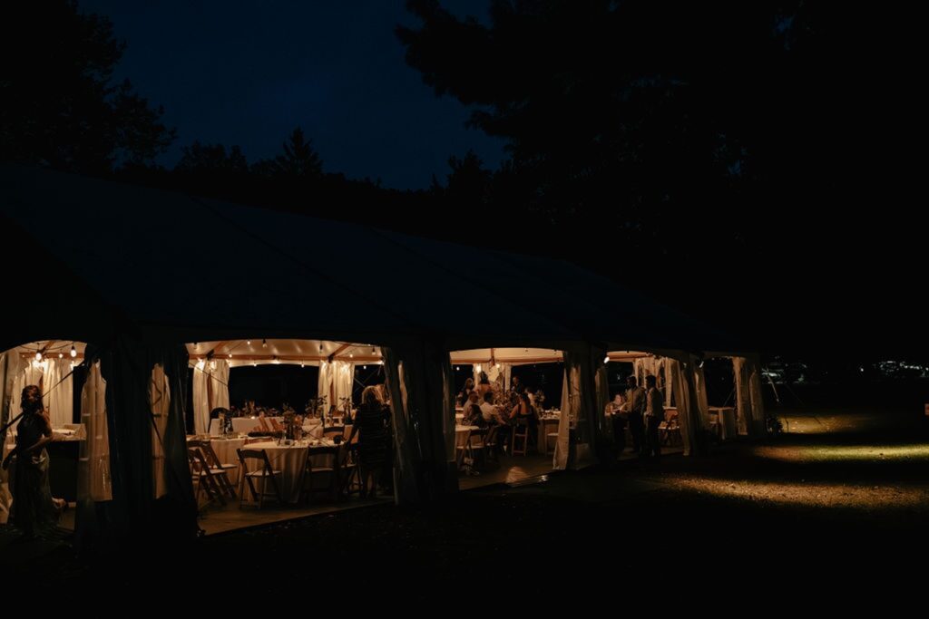 Outside wedding tent lit by lights at hines hill campus