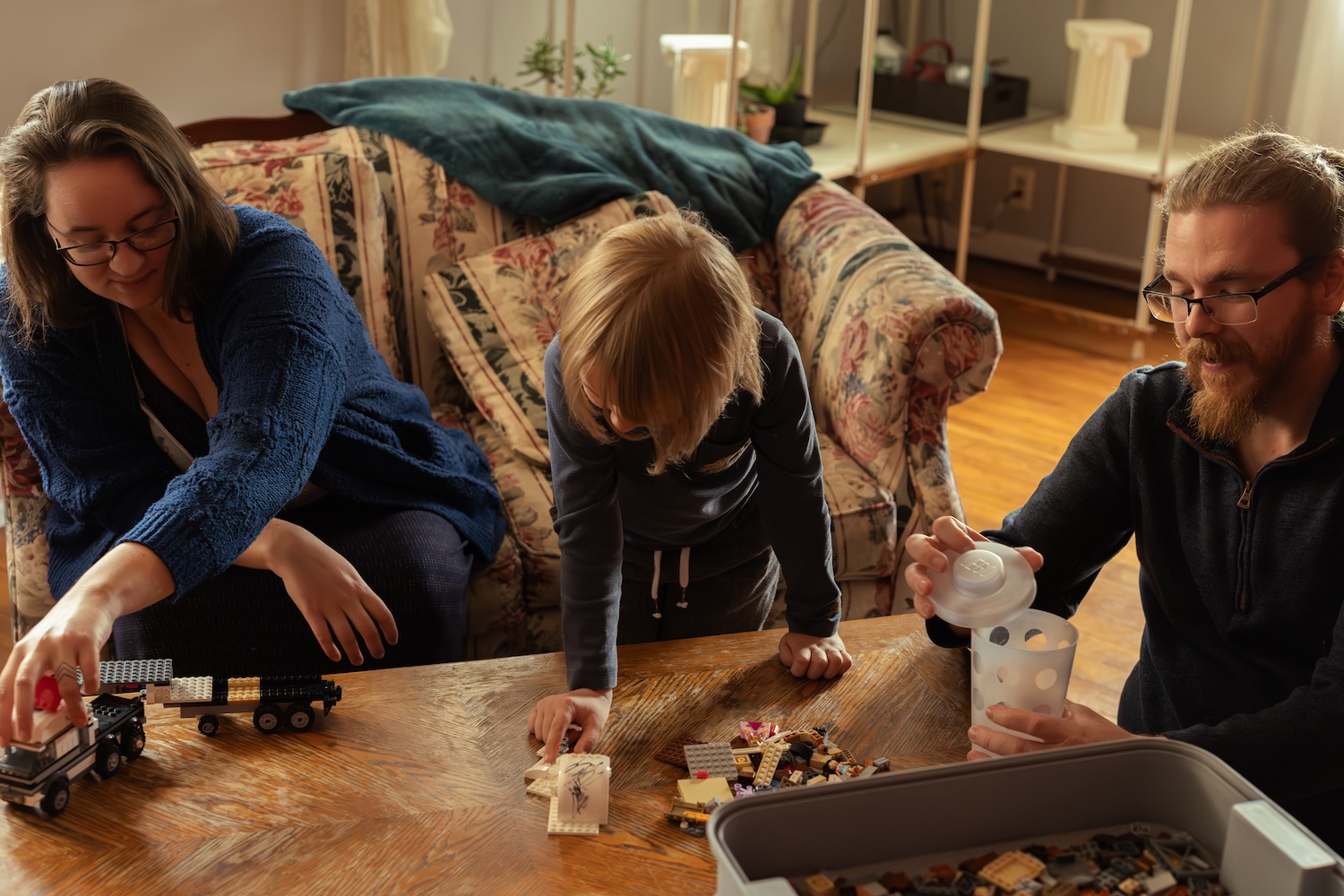 candid photo of a family playing with legos together